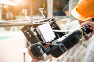 Technicians install fiber optic carbinet.