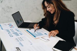 usiness analyzing investment charts with calculator laptop. Accounting and technology in office.Business people using laptop at office,Analyze plans.selective focus.