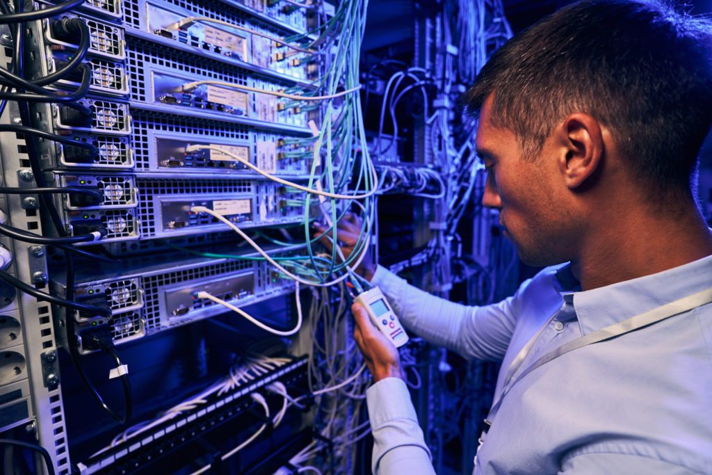 Maintenance technician performing diagnostic test of optical networks